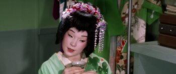 Movie still from “My Geisha” (1962), directed by Jack Cardiff – A geisha is holding a cup in her hands; Close Up shot, High angle