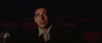 Movie still from “My Geisha” (1962), directed by Jack Cardiff – A person wearing a suit and tie; Close Up shot, Low angle