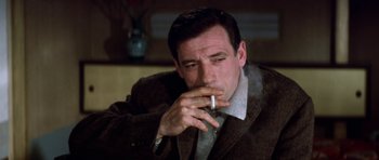 Movie still from “My Geisha” (1962), directed by Jack Cardiff – A person smoking a cigarette; Close Up shot, Low angle