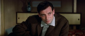 Movie still from “My Geisha” (1962), directed by Jack Cardiff – A person wearing a suit and tie; Close Up shot, Low angle