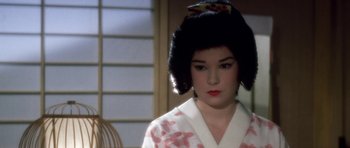 Movie still from “My Geisha” (1962), directed by Jack Cardiff – A woman in a kimono is standing in front of a window; Close Up shot, Over the shoulder angle