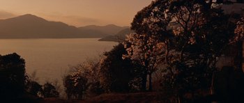 Movie still from “My Geisha” (1962), directed by Jack Cardiff – A view of a body of water with trees in the foreground; Extreme Wide shot, High angle