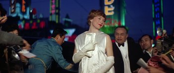 Movie still from “My Geisha” (1962), directed by Jack Cardiff – A woman in a long white dress and gloves; Medium shot, Low angle