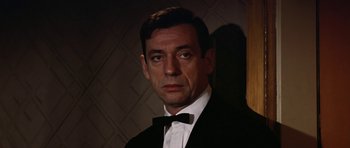 Movie still from “My Geisha” (1962), directed by Jack Cardiff – A person wearing a suit and a bow tie; Close Up shot, Low angle