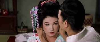 Movie still from “My Geisha” (1962), directed by Jack Cardiff – A man touching a woman's face in front of a mirror; Close Up shot, Over the shoulder angle