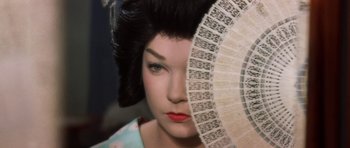 Movie still from “My Geisha” (1962), directed by Jack Cardiff – A person holding a fan; Close Up shot, High angle