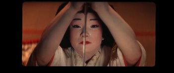 Movie still from “My Geisha” (1962), directed by Jack Cardiff – A geisha is reflected in a mirror; Extreme Close Up shot, High angle