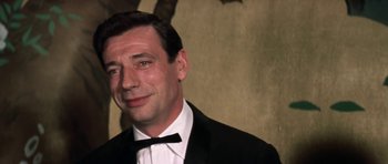 Movie still from “My Geisha” (1962), directed by Jack Cardiff – A person wearing a suit and a bow tie; Close Up shot, Over the shoulder angle