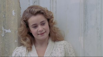 Movie still from “My Left Foot” (1989), directed by Jim Sheridan – A young girl with long hair and a white dress; Close Up shot, High angle