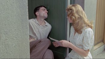 Movie still from “My Left Foot” (1989), directed by Jim Sheridan – A man and a woman are talking to each other outside; Medium shot, Over the shoulder angle