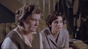 Movie still from “My Left Foot” (1989), directed by Jim Sheridan – Two women sitting next to each other on a couch; Medium shot, High angle