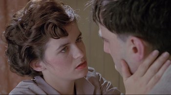 Movie still from “My Left Foot” (1989), directed by Jim Sheridan – A woman and a man face to face in a room; Close Up shot, Over the shoulder angle