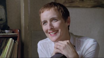 Movie still from “My Left Foot” (1989), directed by Jim Sheridan – A person with short brown hair; Close Up shot, Low angle