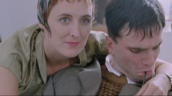 Movie still from “My Left Foot” (1989), directed by Jim Sheridan – A man and a woman sitting next to each other; Close Up shot, High angle