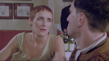 Movie still from “My Left Foot” (1989), directed by Jim Sheridan – A woman sitting next to a man at a dinner table; Close Up shot, Over the shoulder angle