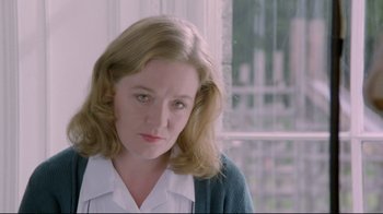 Movie still from “My Left Foot” (1989), directed by Jim Sheridan – A person wearing a sweater; Close Up shot, Low angle