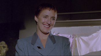 Movie still from “My Left Foot” (1989), directed by Jim Sheridan – A woman with short hair is smiling for the camera; Close Up shot, Low angle