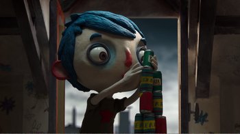 Movie still from “My Life as a Zucchini” (2016), directed by Claude Barras – A person with blue hair is stacking cans; Medium shot, Low angle