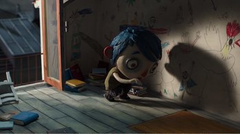 Movie still from “My Life as a Zucchini” (2016), directed by Claude Barras – A cartoon character is sitting on the floor; Wide shot, High angle