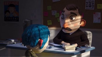 Movie still from “My Life as a Zucchini” (2016), directed by Claude Barras – A man sitting in front of a stuffed bird on top of a desk; Medium shot, Over the shoulder angle
