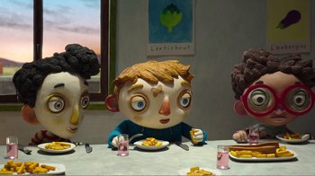Movie still from “My Life as a Zucchini” (2016), directed by Claude Barras – A group of people sitting at a dinner table; Medium shot, Over the shoulder angle