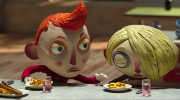 Movie still from “My Life as a Zucchini” (2016), directed by Claude Barras – A couple of people sitting at a table with food; Close Up shot, High angle