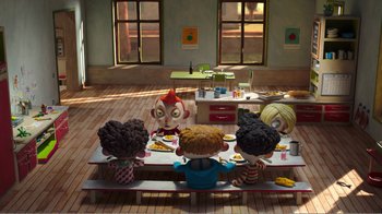 Movie still from “My Life as a Zucchini” (2016), directed by Claude Barras – A group of children sitting at a table eating pizza; Wide shot, High angle
