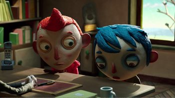 Movie still from “My Life as a Zucchini” (2016), directed by Claude Barras – A couple of people that are sitting at a table together; Medium shot, High angle