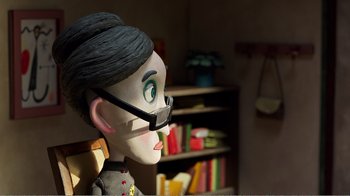 Movie still from “My Life as a Zucchini” (2016), directed by Claude Barras – The face of a doll wearing glasses; Close Up shot, Over the shoulder angle