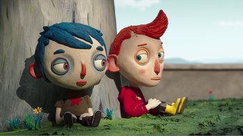Movie still from “My Life as a Zucchini” (2016), directed by Claude Barras – A couple of cartoon dolls sitting next to a tree; Medium shot, High angle