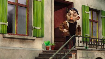 Movie still from “My Life as a Zucchini” (2016), directed by Claude Barras – A man with a mustache and a hat is walking down the stairs; Wide shot, Over the shoulder angle