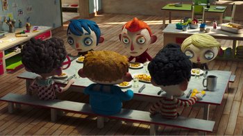 Movie still from “My Life as a Zucchini” (2016), directed by Claude Barras – A group of children sitting at a table with plates of food on it; Wide shot, High angle