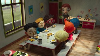 Movie still from “My Life as a Zucchini” (2016), directed by Claude Barras – A group of people sitting around a table eating; Wide shot, High angle
