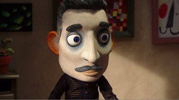 Movie still from “My Life as a Zucchini” (2016), directed by Claude Barras – The face of a doll with a mustache; Close Up shot, Over the shoulder angle