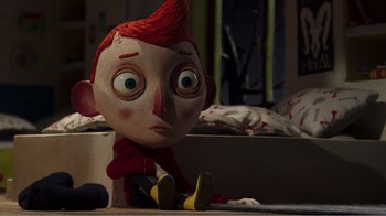 Movie still from “My Life as a Zucchini” (2016), directed by Claude Barras – A doll is sitting on the floor next to a bed; Close Up shot, High angle