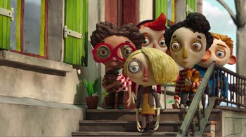 Movie still from “My Life as a Zucchini” (2016), directed by Claude Barras – A group of people standing next to each other on steps; Wide shot, Low angle