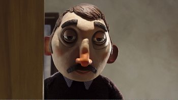 Movie still from “My Life as a Zucchini” (2016), directed by Claude Barras – The face of a man wearing a fake mustache; Close Up shot, Low angle