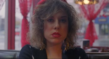 Movie still from “My Own Private Idaho” (1991), directed by Gus Van Sant – A person wearing a red hat; Close Up shot, Over the shoulder angle