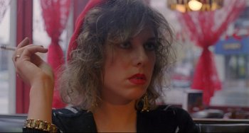 Movie still from “My Own Private Idaho” (1991), directed by Gus Van Sant – A person wearing a red hat; Close Up shot, Over the shoulder angle