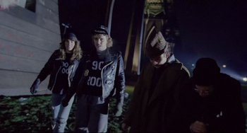 Movie still from “My Own Private Idaho” (1991), directed by Gus Van Sant – A group of people standing next to each other on a field; Medium shot, High angle