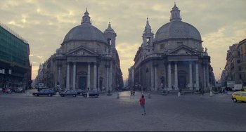 Movie still from “My Own Private Idaho” (1991), directed by Gus Van Sant – A person standing in front of two large domed buildings; Extreme Wide shot, High angle