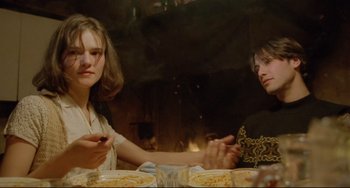 Movie still from “My Own Private Idaho” (1991), directed by Gus Van Sant – Two people sitting at a dinner table eating pasta; Medium shot, Over the shoulder angle