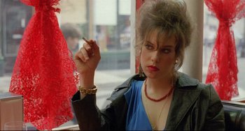 Movie still from “My Own Private Idaho” (1991), directed by Gus Van Sant – A woman sitting in front of a window with a cigarette in her hand; Close Up shot, Over the shoulder angle