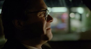 Movie still from “My Own Private Idaho” (1991), directed by Gus Van Sant – A person wearing glasses and a suit; Close Up shot, Over the shoulder angle