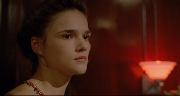 Movie still from “My Own Private Idaho” (1991), directed by Gus Van Sant – A young woman looking to her left while wearing a red necklace; Close Up shot, Over the shoulder angle
