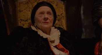 Movie still from “My Own Private Idaho” (1991), directed by Gus Van Sant – An old woman wearing a black hat and a black coat; Close Up shot, High angle