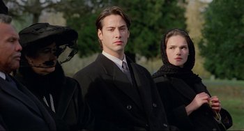 Movie still from “My Own Private Idaho” (1991), directed by Gus Van Sant – A man and two women wearing black suits and headscarves; Close Up shot, Low angle