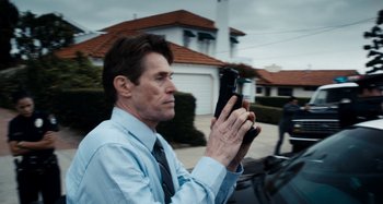 Movie still from “My Son, My Son, What Have Ye Done” (2009), directed by Werner Herzog – A man holding a cell phone while sitting in a car; Close Up shot, Low angle