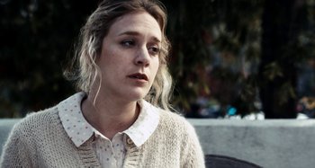 Movie still from “My Son, My Son, What Have Ye Done” (2009), directed by Werner Herzog – A young woman with long blonde hair wearing a white shirt; Close Up shot, Over the shoulder angle