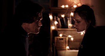 Movie still from “My Son, My Son, What Have Ye Done” (2009), directed by Werner Herzog – A man and a woman face to face in a dark room; Close Up shot, Over the shoulder angle